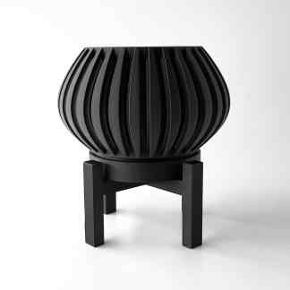 Black 3D-printed plant pot with ribbed design, displayed on a sturdy black stand, highlighting advanced 3D printing craftsmanship.