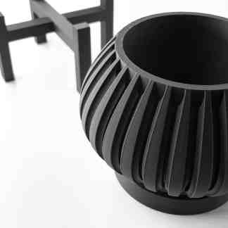 Detailed black 3D-printed turbine part showcasing intricate design.
