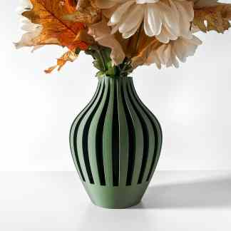 Elegant 3D-printed green vase with striped design holding artificial flowers and autumn leaves.
