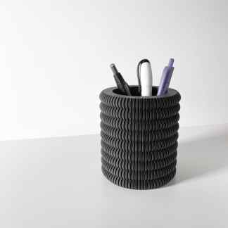 Stylish black flexible ribbed pen holder containing pens and markers, ideal for desk organization and office supplies.