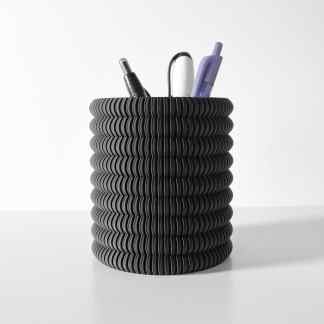 Black spiral pen holder with purple, white, and black pens on a white surface.