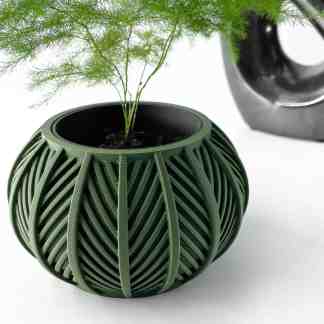 A modern, green 3D-printed plant pot featuring a unique leaf pattern, perfect for home decor and garden styling.