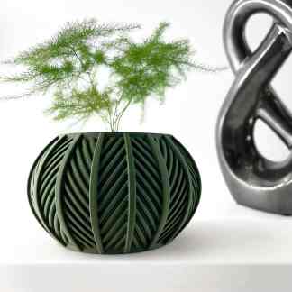 Stylish green 3D-printed flower vase with modern geometric pattern and plant inside.