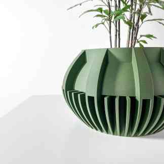 3D printed green plant pot with unique geometric pattern, perfect for modern interior decor.