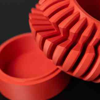 High-quality 3D-printed gear with intricate details and vibrant orange color, showcasing advanced manufacturing.