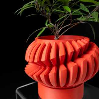 Vase with 3D printed geometric pattern, used as a stylish plant holder, highlighting creative 3D printing solutions.