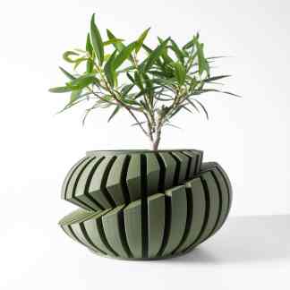 Vibrant green plant in a stylish, innovative 3D-printed pot with geometric patterns.