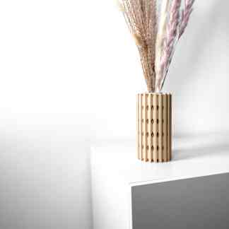 Elegant 3D printed wooden vase holding dried pampas grass for contemporary home decor.