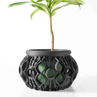 3D-printed modern geometric plant pot with a green plant, showcasing innovative design.