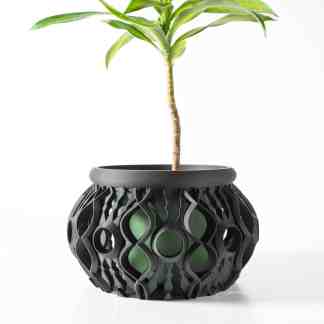 3D printed flower pot with complex black lattice structure and vibrant green interior.