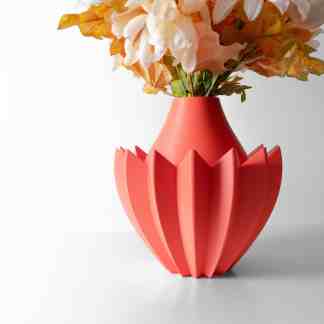 Colorful 3D printed vase with modern geometric pattern holding flowers.