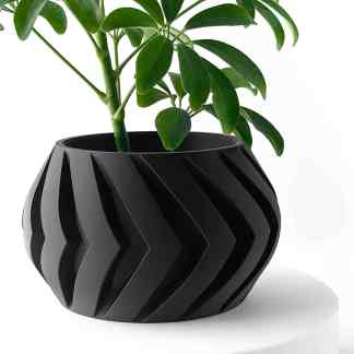 Black 3D-printed geometric flower pot with lush green plant, modern home decor, innovative 3D printing art.