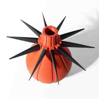 Detailed orange plant pot with black spikes, showcasing innovative 3D printing design.