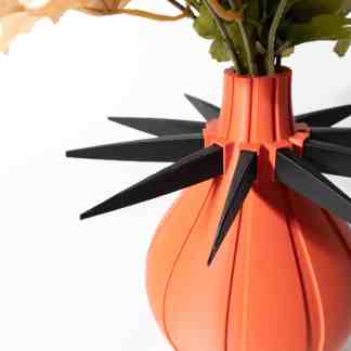 Detailed close-up of a modern, 3D printed flower vase with unique spiky black accents, showcasing innovative 3D printing techniques.