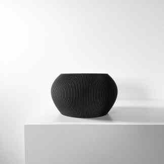 Sleek black ceramic vase with textured ribbed surface, ideal for modern interior decor accents.