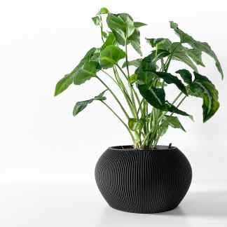 Artificial plant in sleek black 3D-printed pot for stylish home or office decoration.