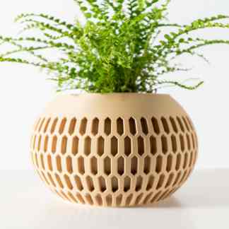 Vase with intricate hexagonal cutout pattern, perfect for contemporary interior decor and plant displays.