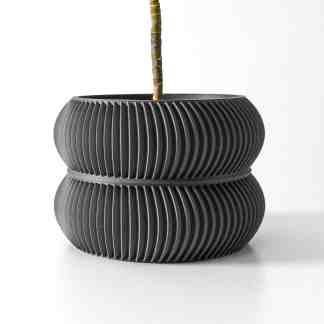 Black textured 3D-printed planter with ribbed surface for stylish plant display.