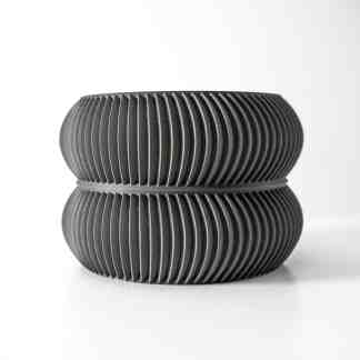 Sleek black ceramic vases featuring intricate ribbed textures, perfect for modern home decor and artistic displays.
