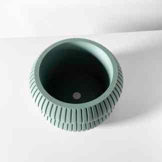 Modern green ceramic vase with textured surface, ideal for interior styling and artistic decor.