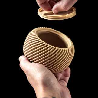 Close-up of a handcrafted 3D-printed vase featuring intricate ribbed patterns, showcasing advanced 3D printing technology.