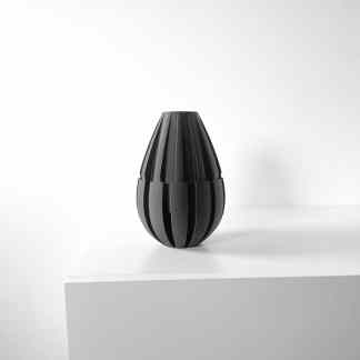 Elegant black 3D-designed vase on white pedestal for modern decor.