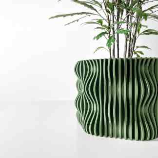 Vivid green 3D-printed plant pot with intricate wavy design, perfect for home decor.