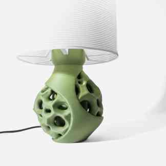 A stylish 3D-printed table lamp featuring an intricate organic design in light green, ideal for modern interiors.