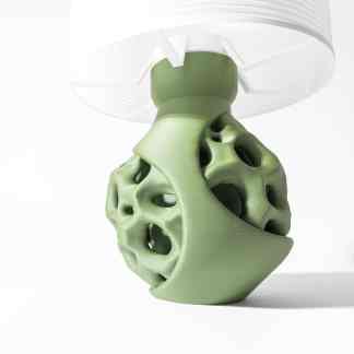 Detailed close-up of a modern 3D-printed light fixture with a green geometric base and white shade.