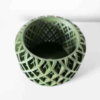 Detailed view of a green 3D-printed lattice-designed geometric tube.