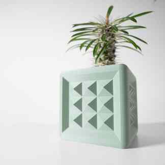 Vibrant green succulent plant in a modern, textured 3D-printed geometric planter for contemporary interior design.