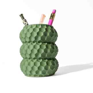 Green 3D-printed hexagon textured pen holder for stationery storage.