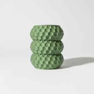 3D printed green hexagon-patterned vase on white background.