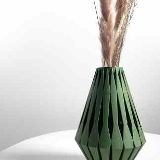 High-quality 3D printed green vase featuring geometric patterns, paired with dried flowers for contemporary interior styling.