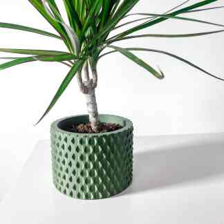 3D printed green plant pot with textured geometric design for interior decoration.