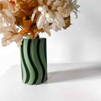 Artificial flower arrangement in green vase with artificial blooms for home decor.