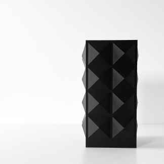 Sleek black 3D printed geometric sculpture with angular facets, displayed on a white surface for modern decor.