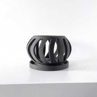 Modern black geometric 3D printed sculpture on white background.