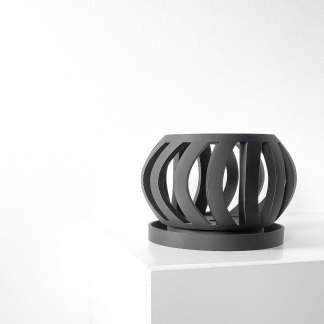Elegant black 3D printed sculpture with open curved design, displayed on white pedestal.