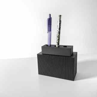 Stylish black pen holder with two pens, ideal for organizing stationery on a modern workspace.