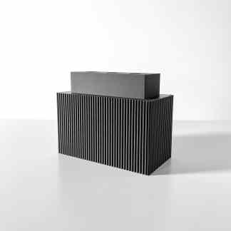 Sleek 3D-printed speaker with ribbed texture, black finish, ideal for modern audio setups.