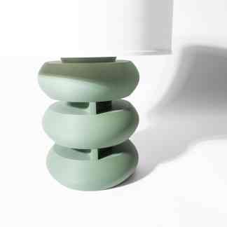Stylish green lamp with layered circular structure, modern and minimalist design for living rooms.