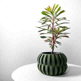 Bright green, uniquely patterned 3D-printed flower pot with a plant, emphasizing custom 3D printed home decor.