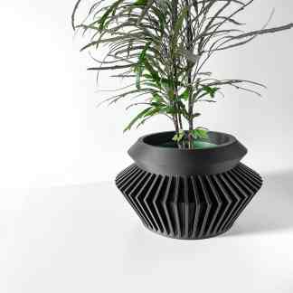 3D printed black geometric planter holding a houseplant, showcasing innovative design and modern aesthetics.