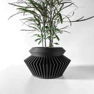 High-resolution image of a sleek, black 3D printed planter with angular, geometric patterns for contemporary interior design.