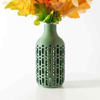 Elegant green RAKO glass vase showcasing intricate cut-out patterns, perfect for floral decor.