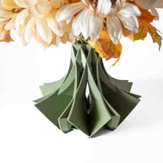 Detailed view of handcrafted paper flowers in a modern geometric green paper vase.