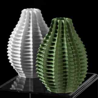 Detailed 3D printed vases in white and green on display.