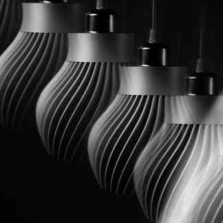 Sleek 3D-printed lamps with intricate spiral patterns, emphasizing modern lighting solutions and 3D printing technology.