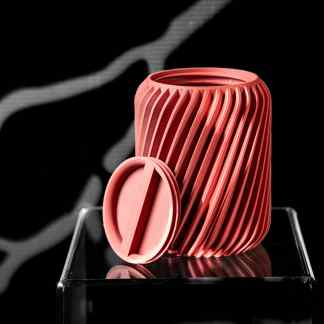 Vivid pink 3D printed ridged container with removable lid, showcasing advanced design and precision.
